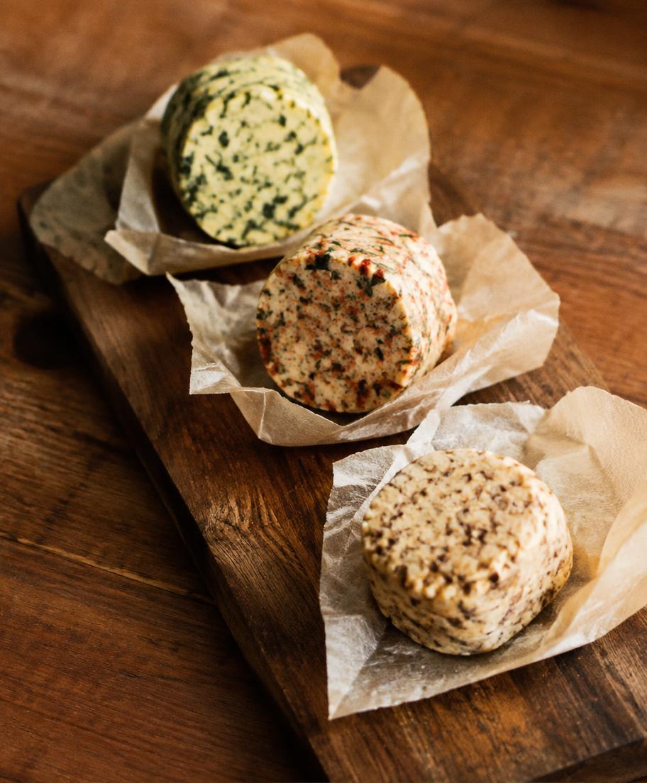 Three rounds of herb and spice compound butter on parchment